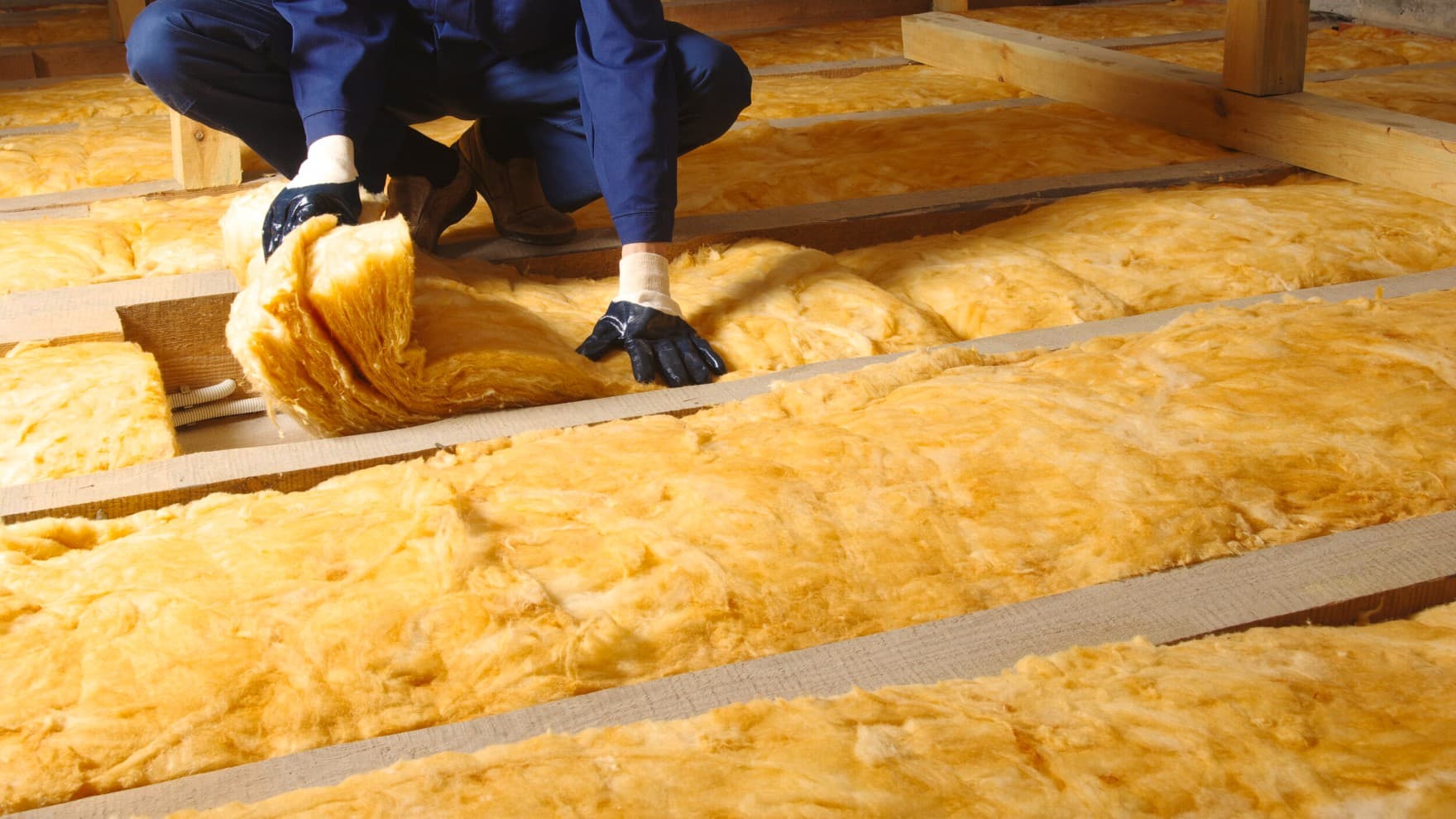 man wearing PPE installing underfloor heating