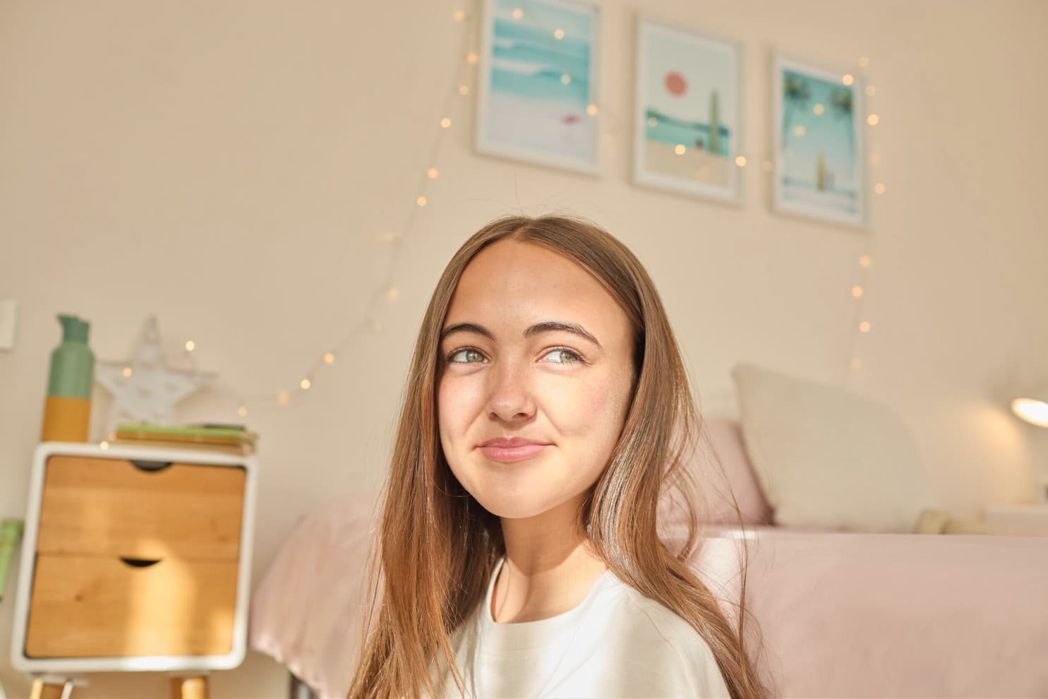 Girl sitting in a room looking out the window