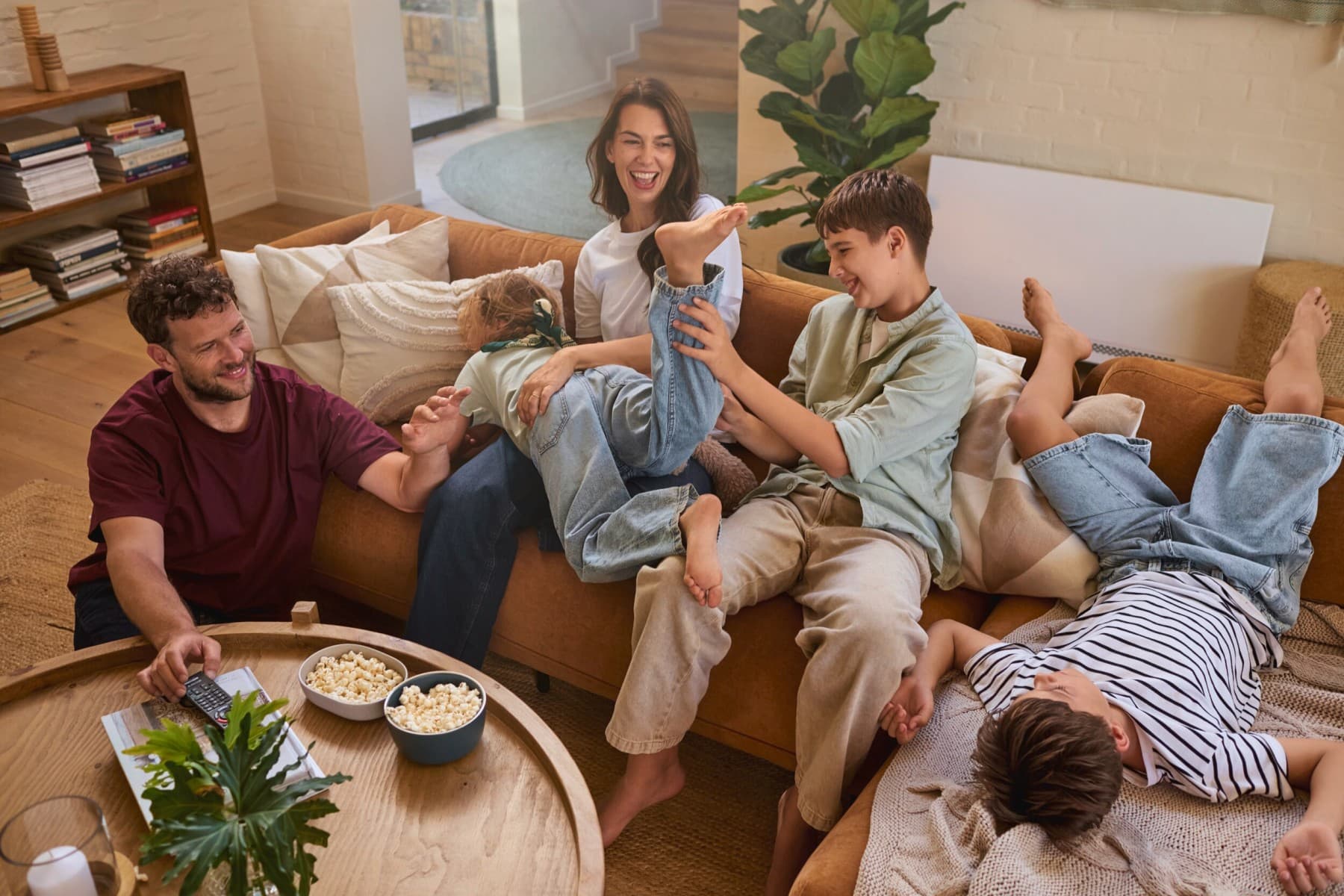 Family romping on sofa