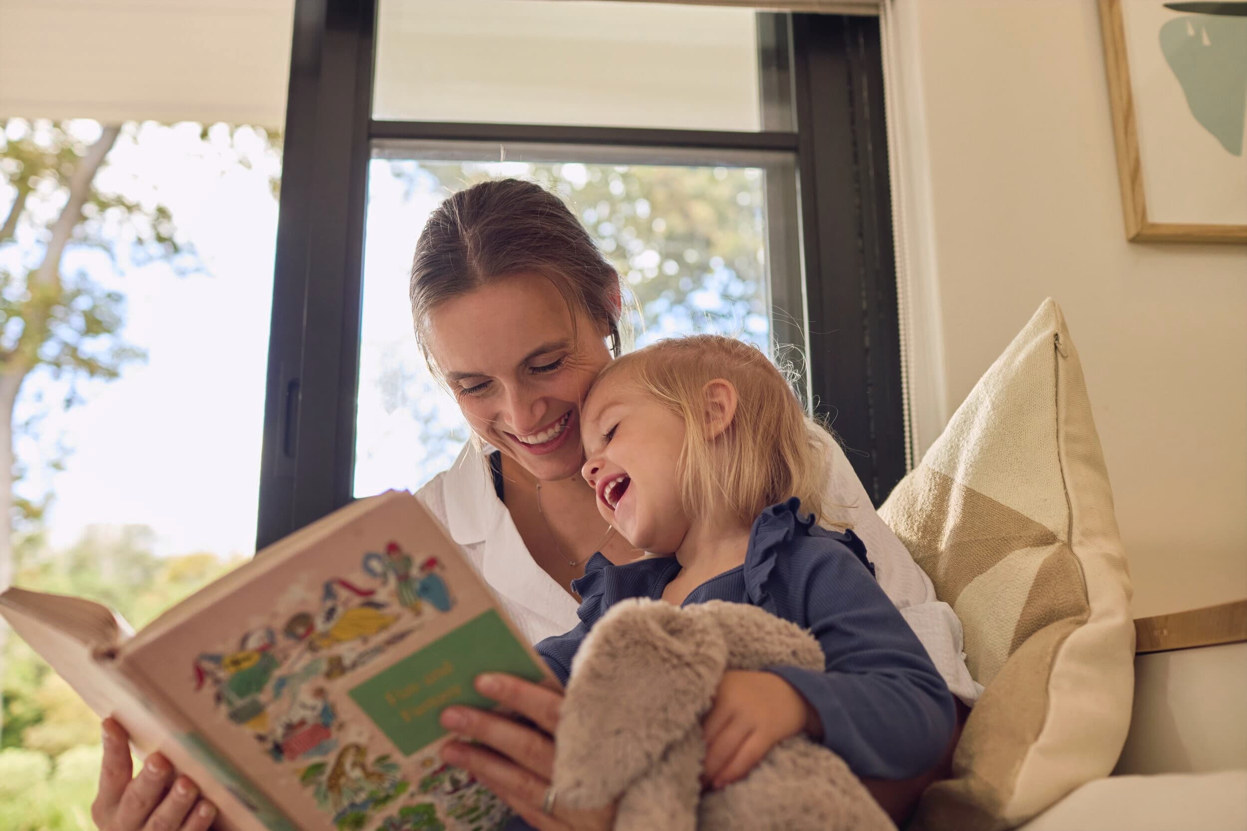 A mother reads to her child from a book