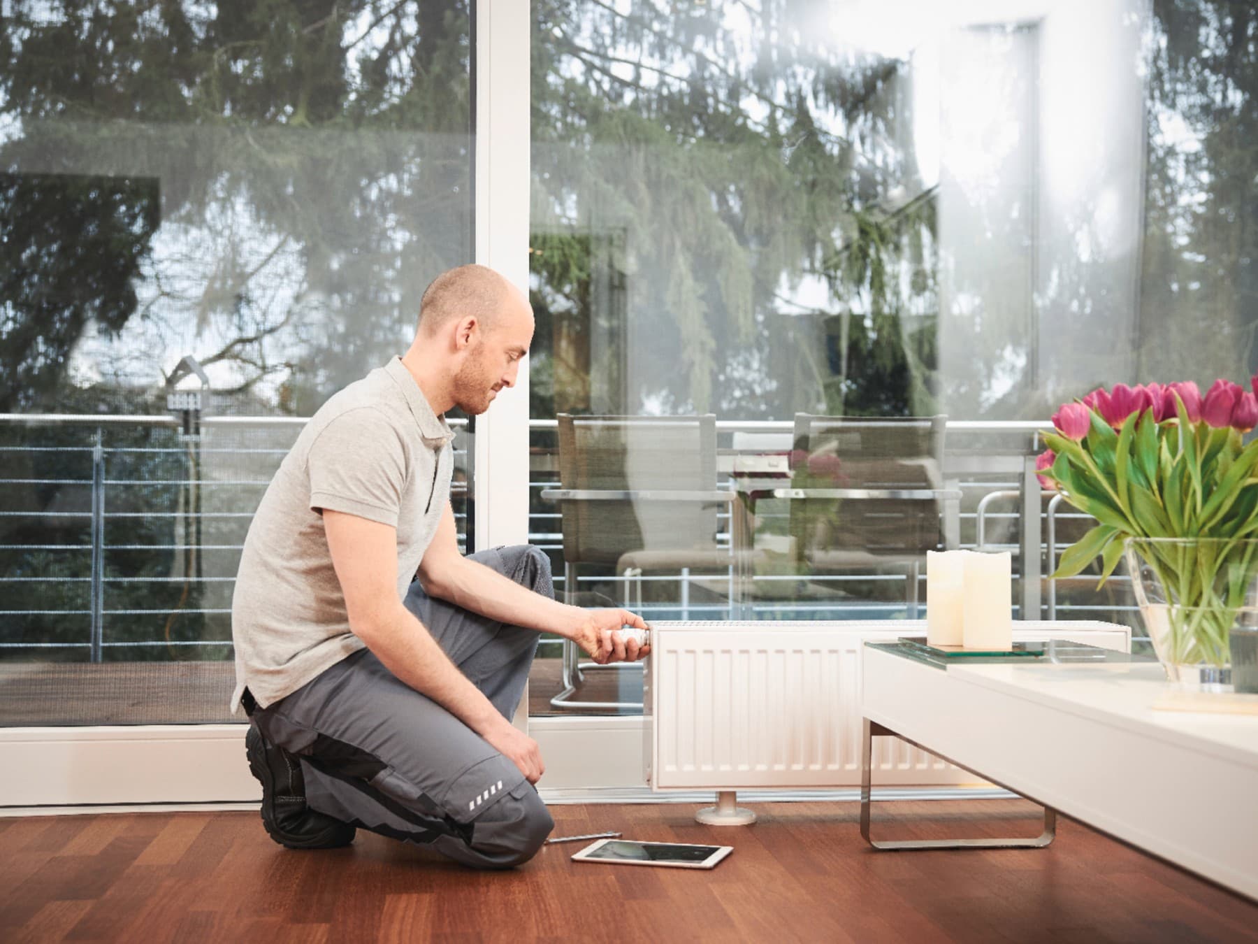 Professional installer balancing a radiator