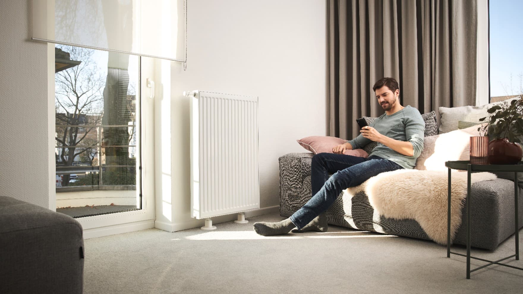Men sitting on the sofa in front of a radiator