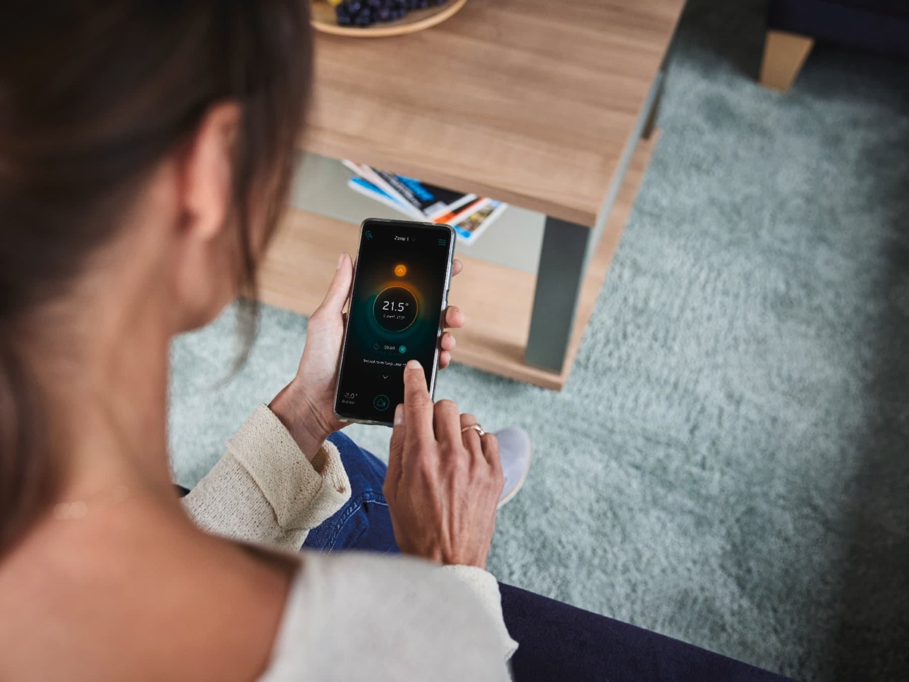 Woman adjusting her smart system on the phone.
