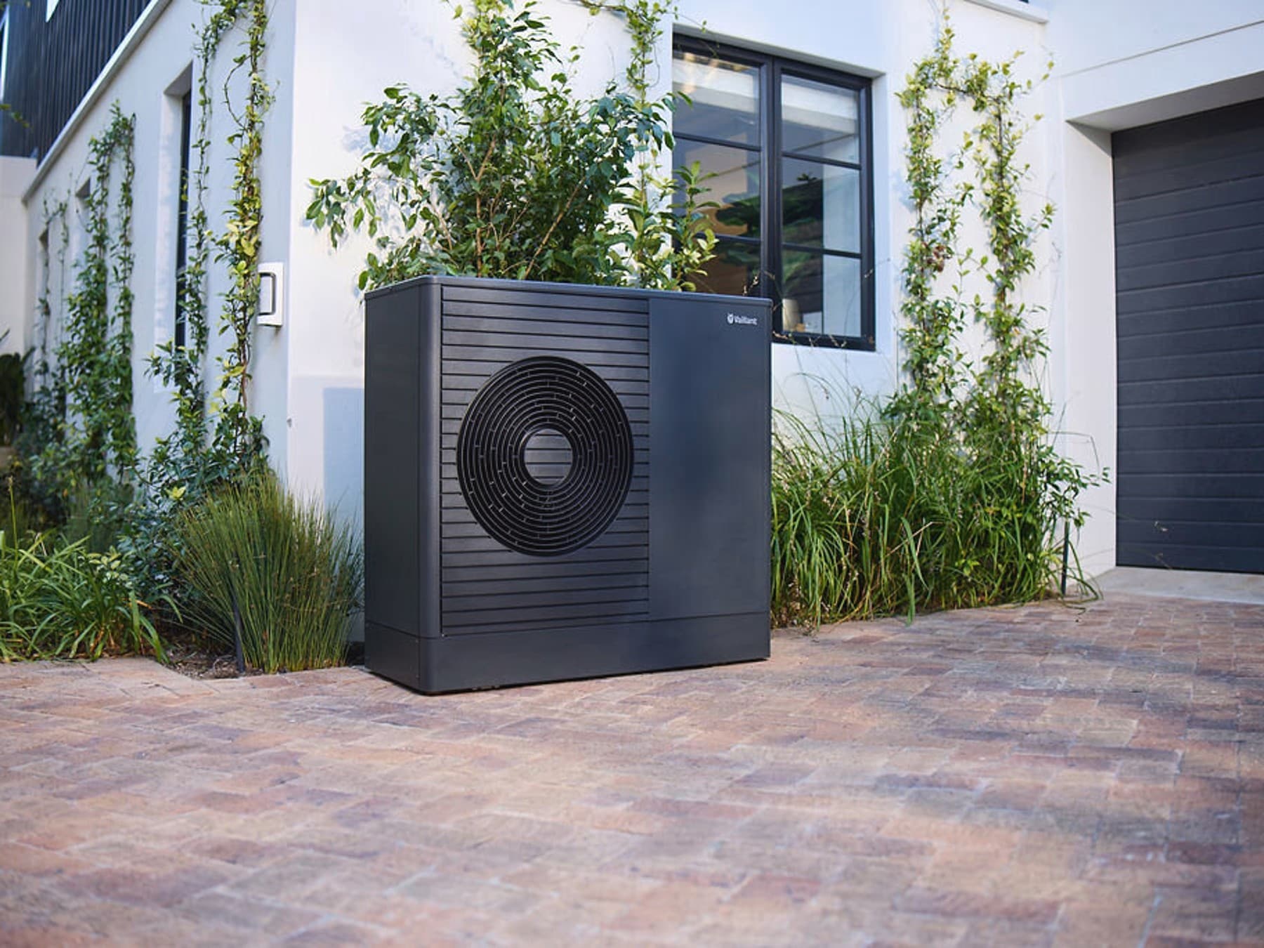 Heat pump standing in front of a house