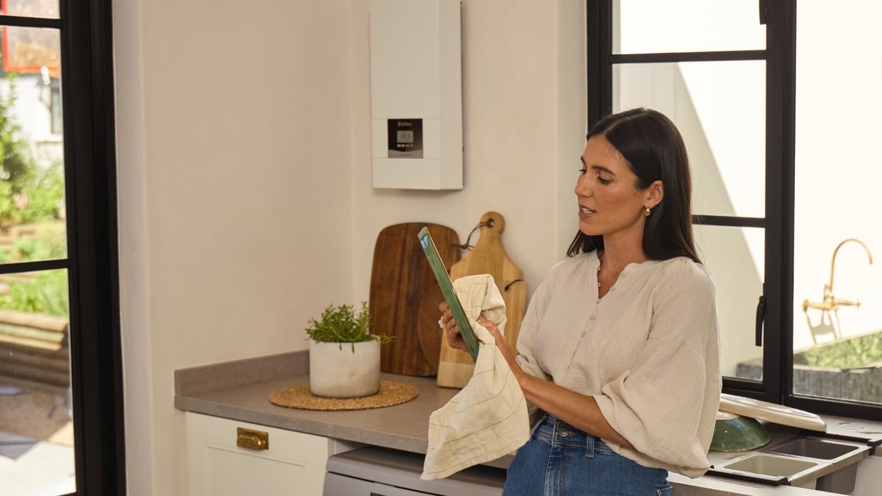 Woman in a kitchen in front of an electric heater