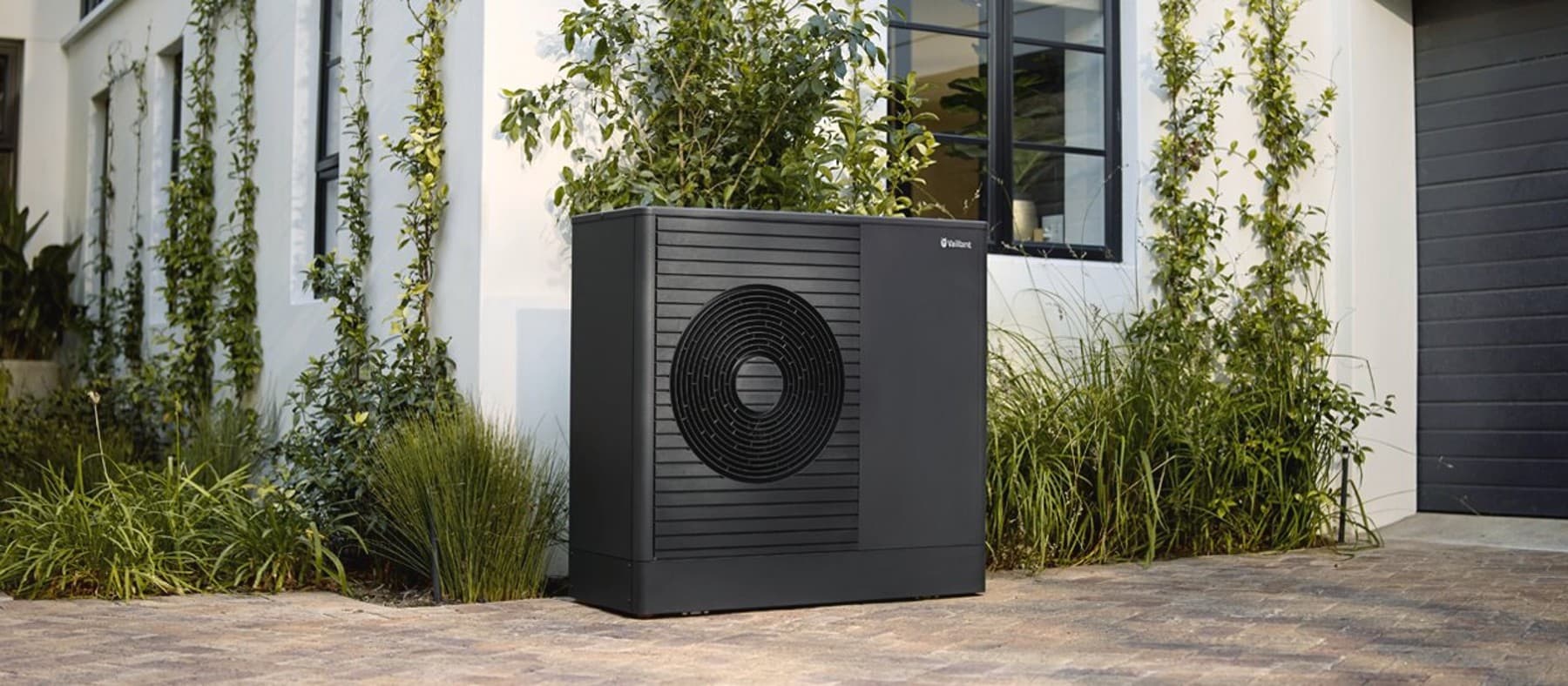 Heat pump standing in the front of a house