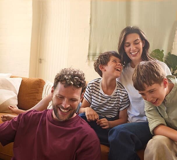 Family sitting on a couch in the living room