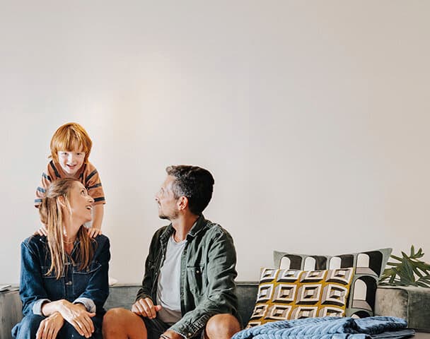 Family is sitting on the coach in the living room