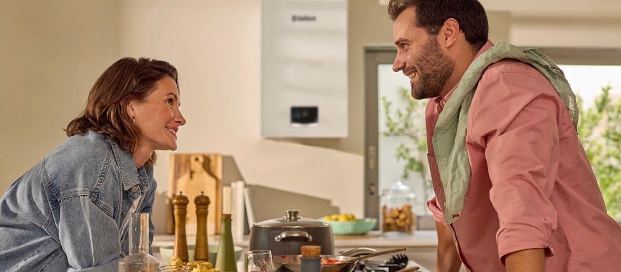 Couple standing in the kitchen looking at each other