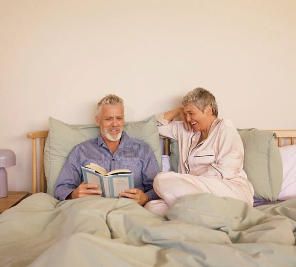 Couple sitting in the bed