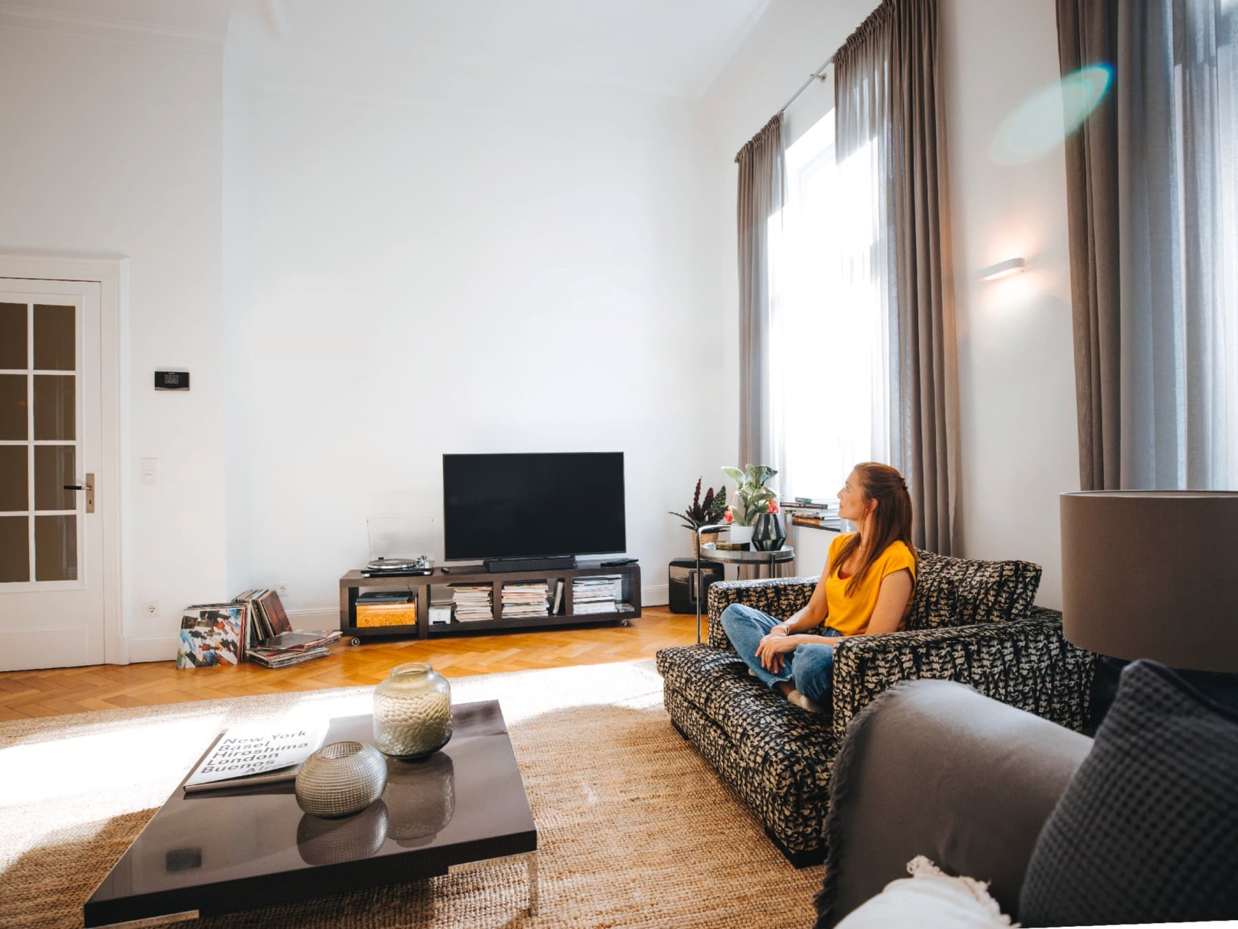 Woman sitting on her sofa, enjoying the peace and quiet at the perfect temperature
