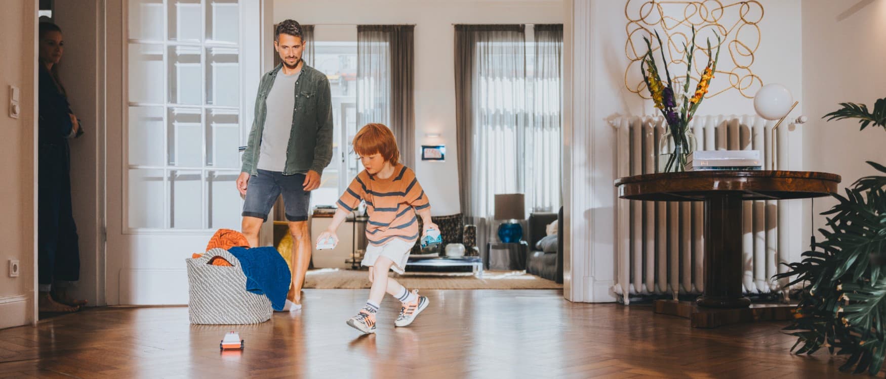 Father watches his son playing in the living room