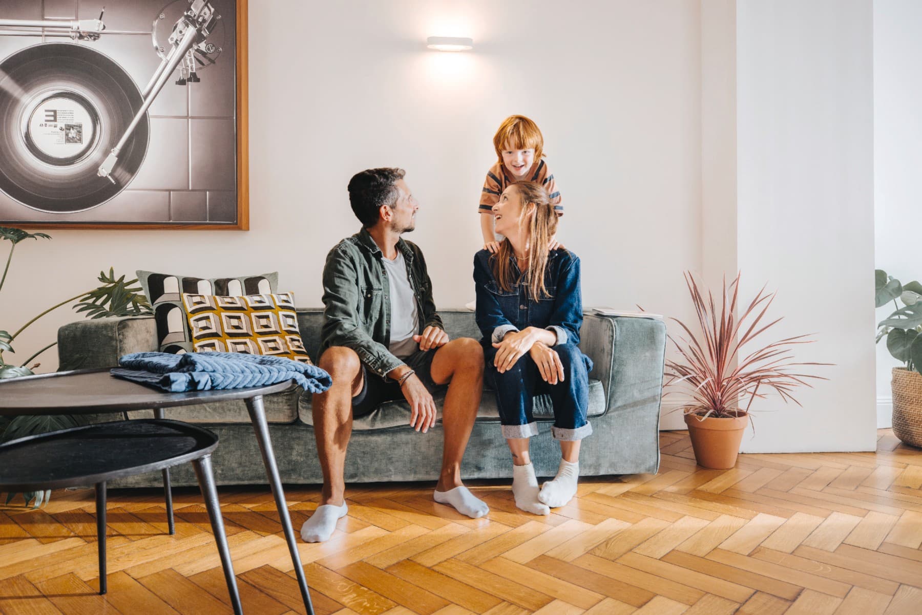 Family sits on a couch in a living room
