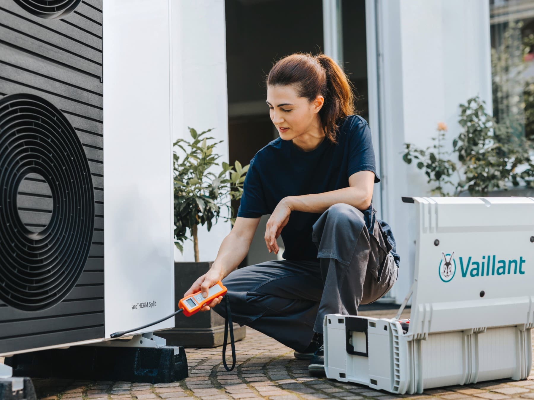 An engineer is carrying out maintenance work on a heat pump