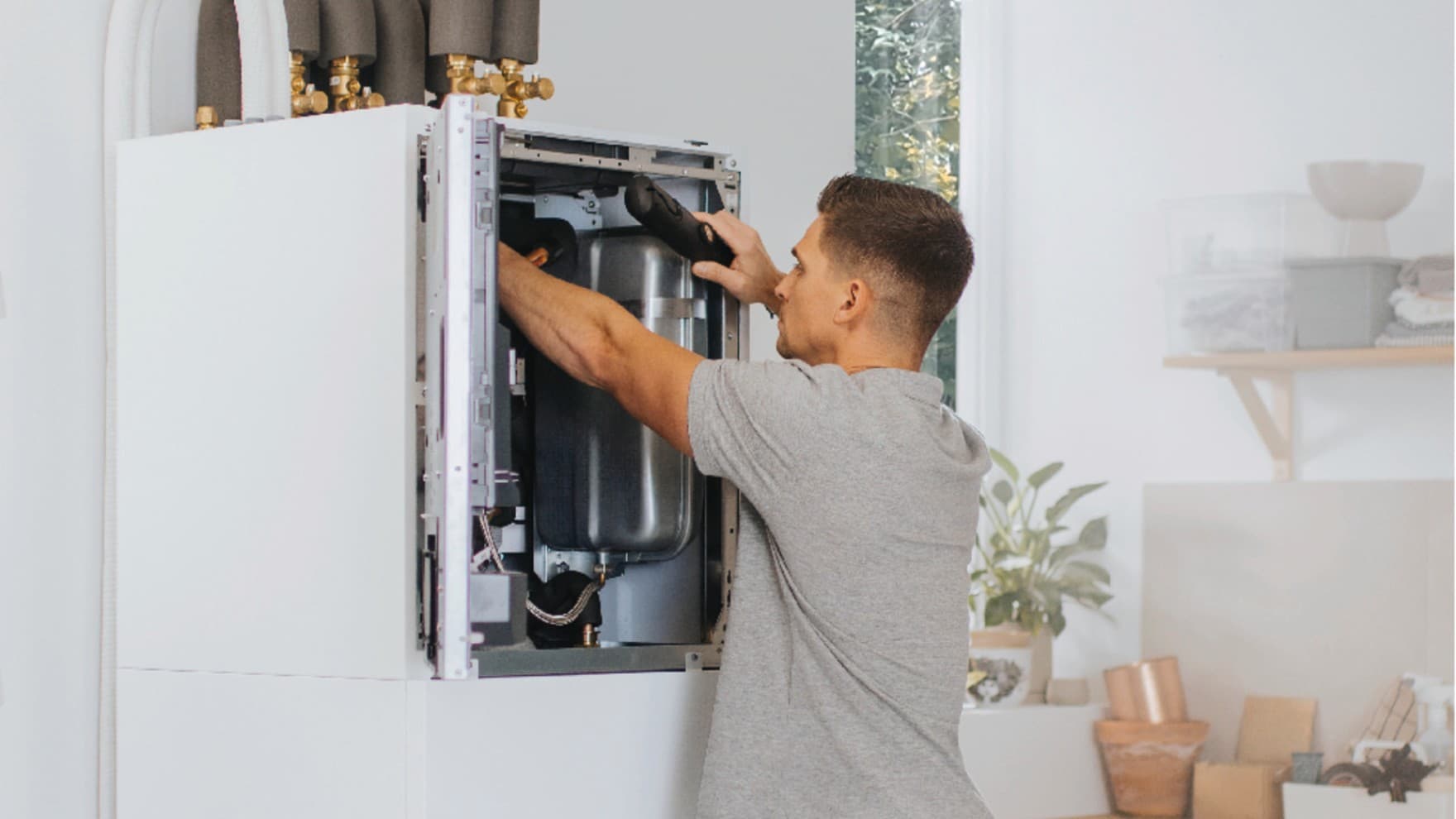 Installer working on an inside unit of a heat pump