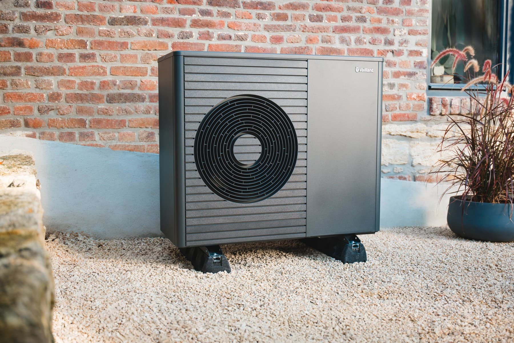 Heat pump in front of a house wall