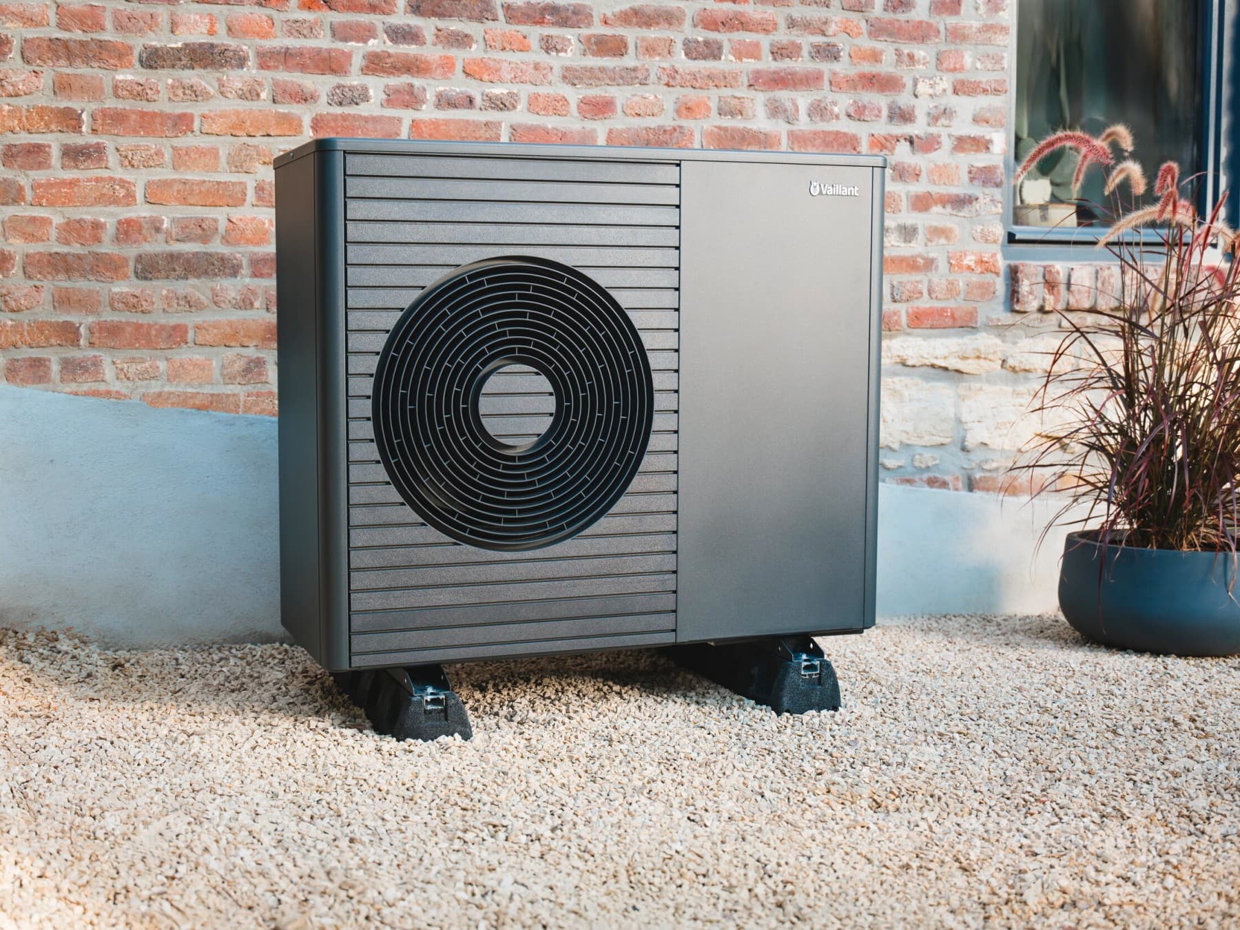 Heat pump in front of a house wall