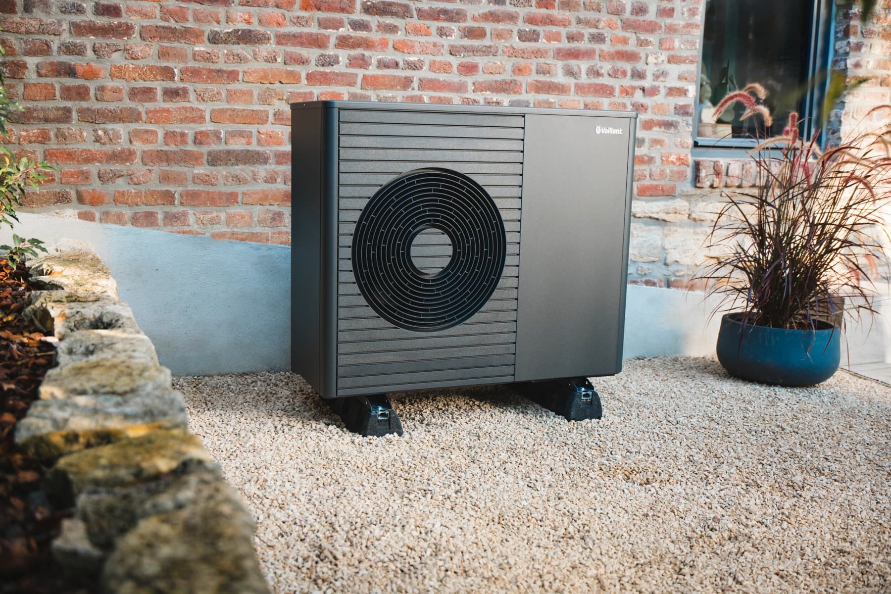Heat pump in front of a house wall