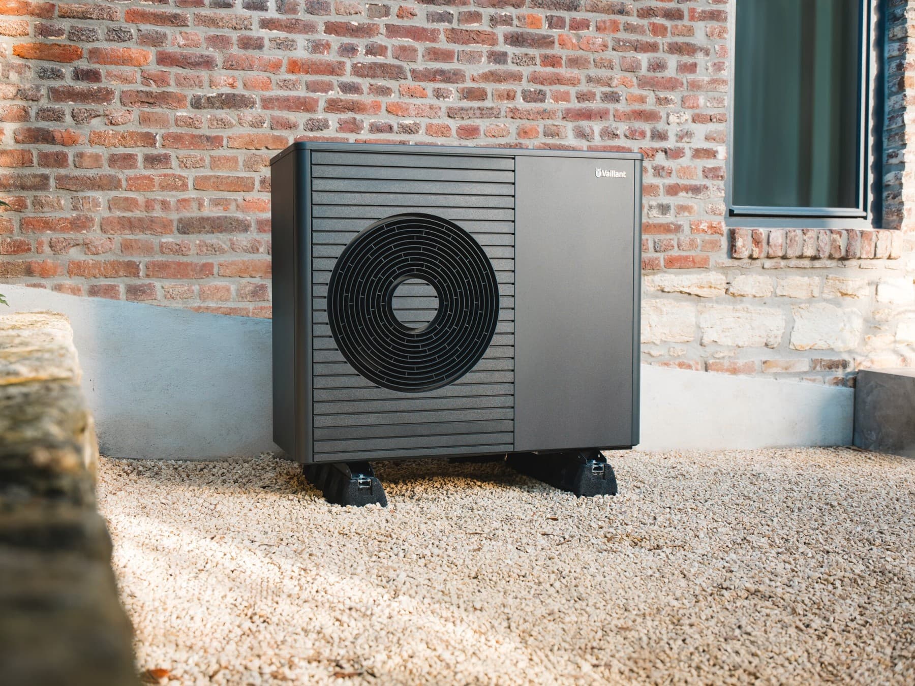 Vaillant heat pump in front of a house