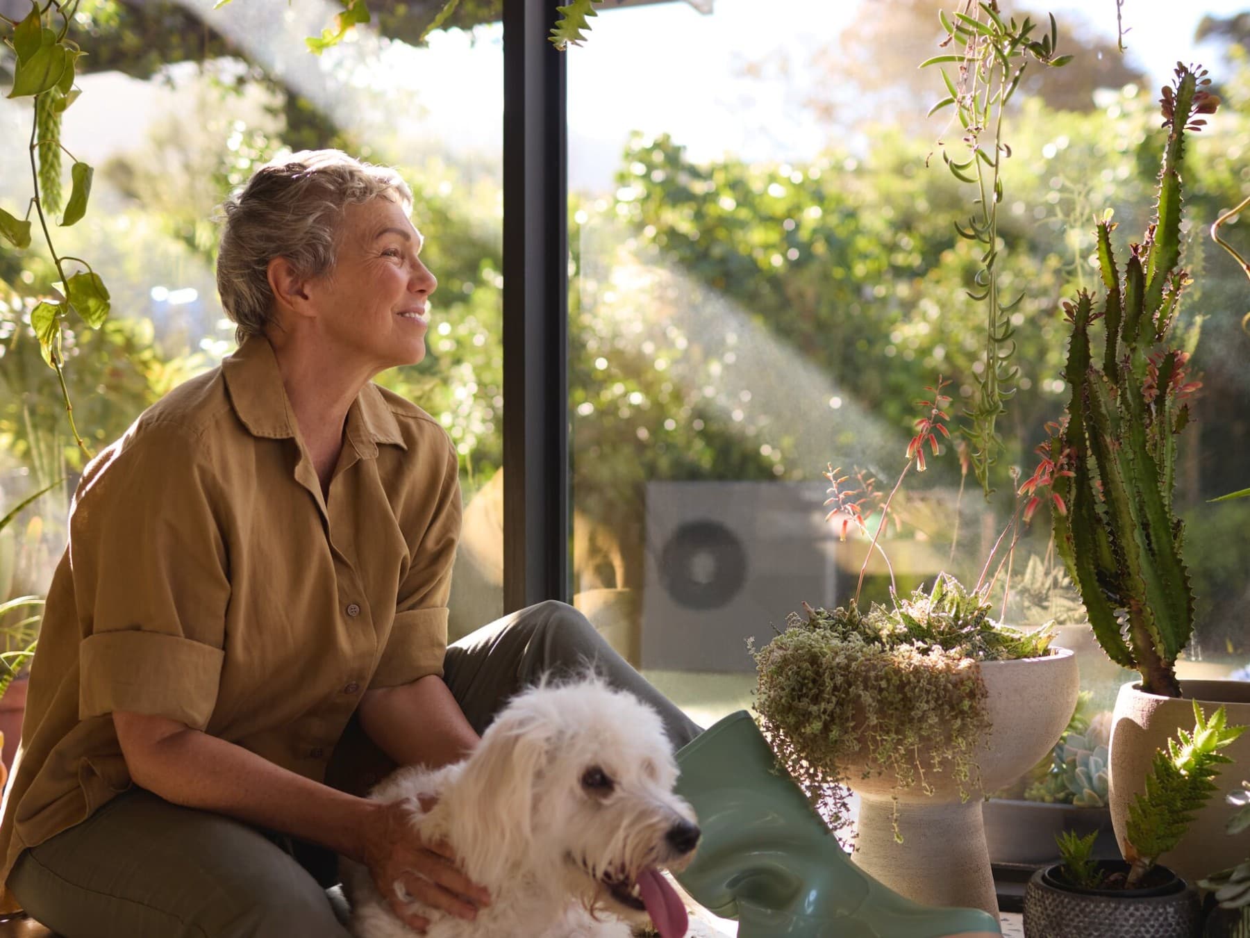 Air-to-water heat pump behind a woman and a dog