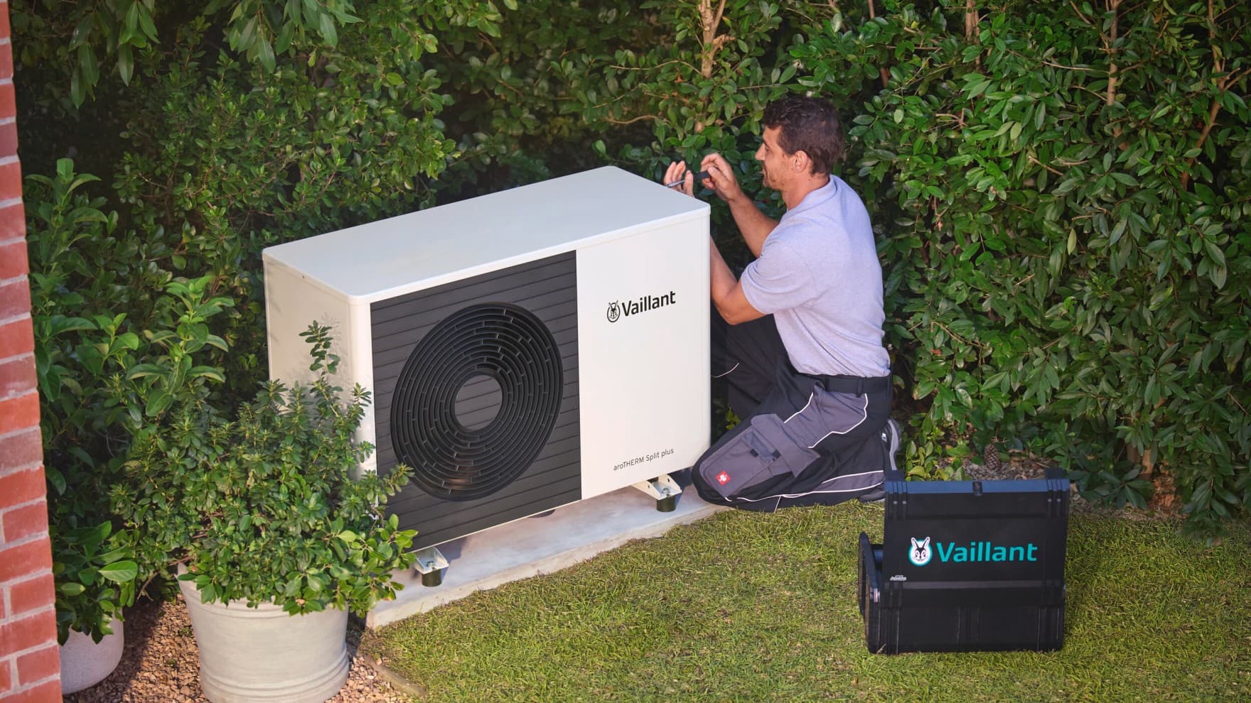 An installer checking a heat pump with a tool