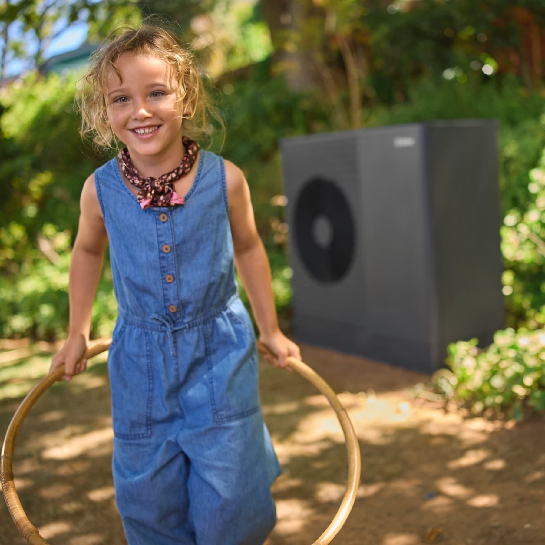 A girl is playing in front of a Vaillant aroTHERM plus heat pump