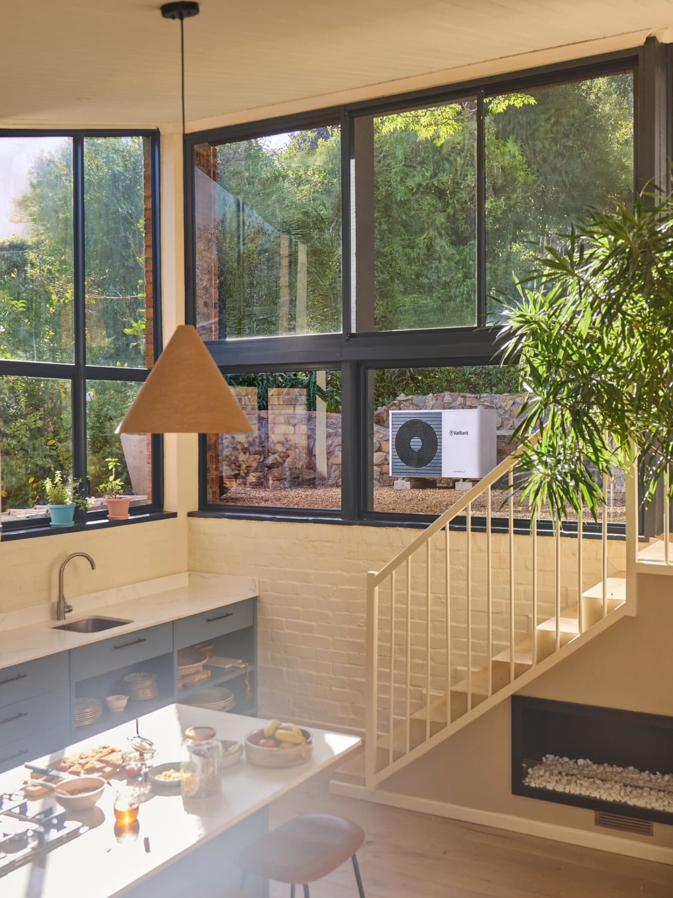 Vaillant heat pump in the garden visible through the window