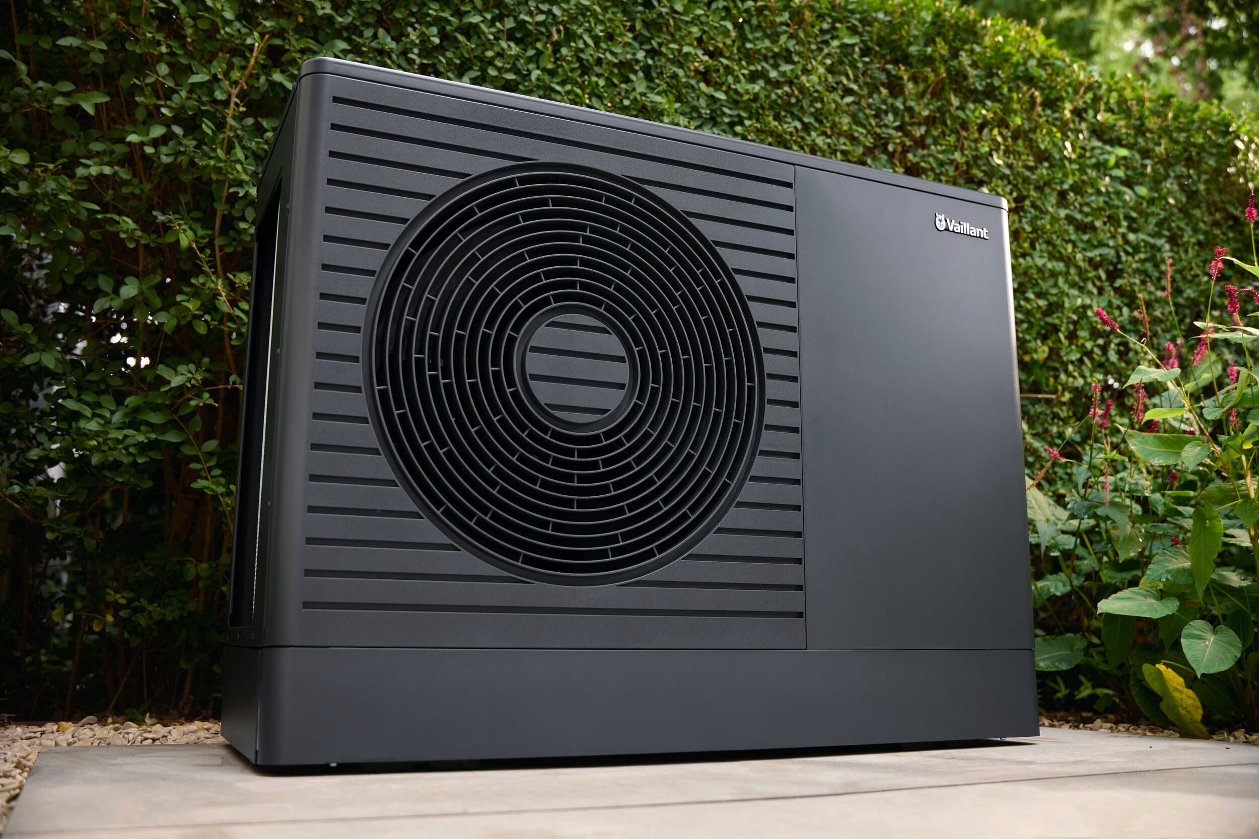 aroTHERM pro air-to-water heat pump in front of a hedge