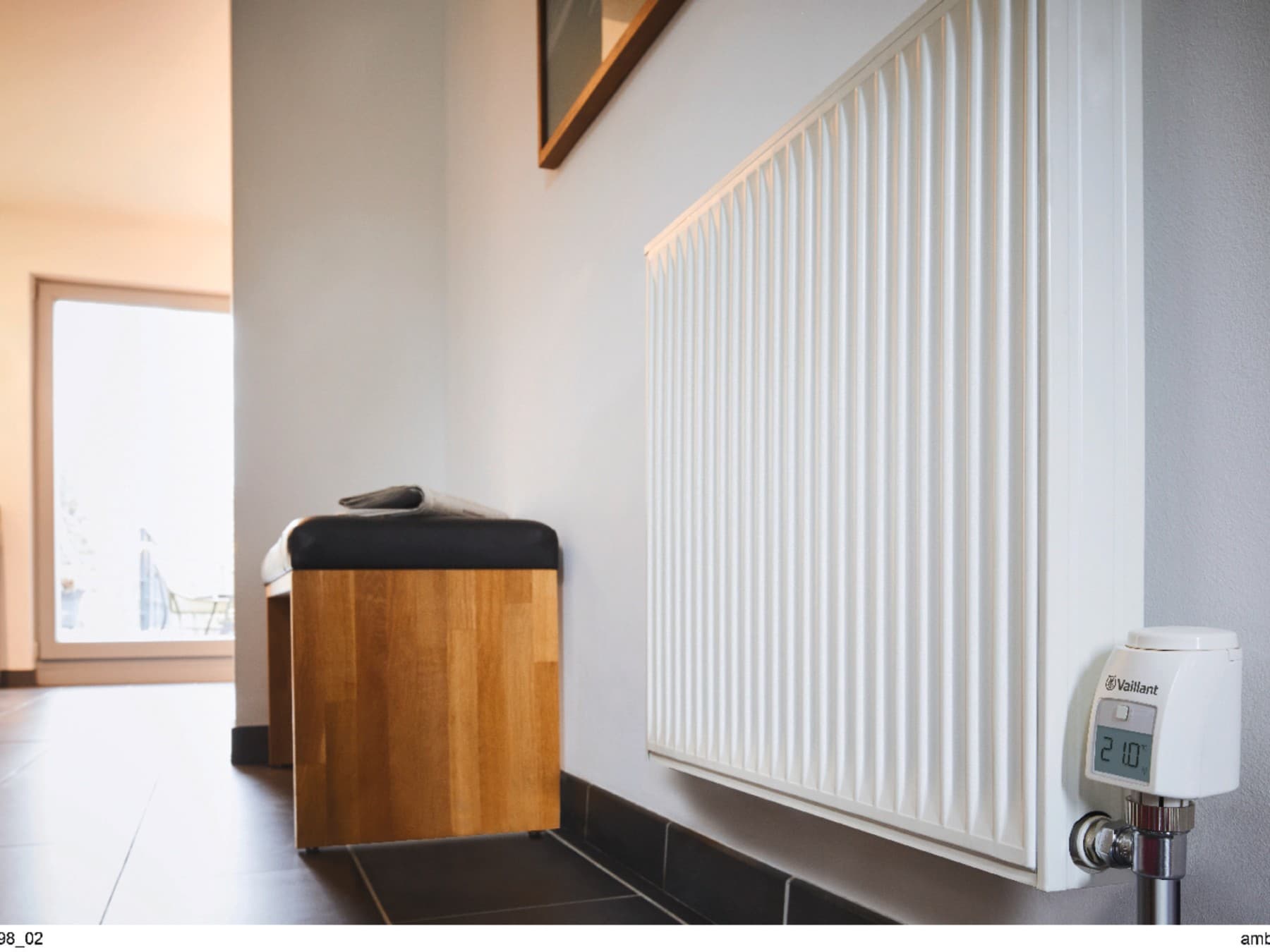 Radiator with a Vaillant thermostat in a bathroom