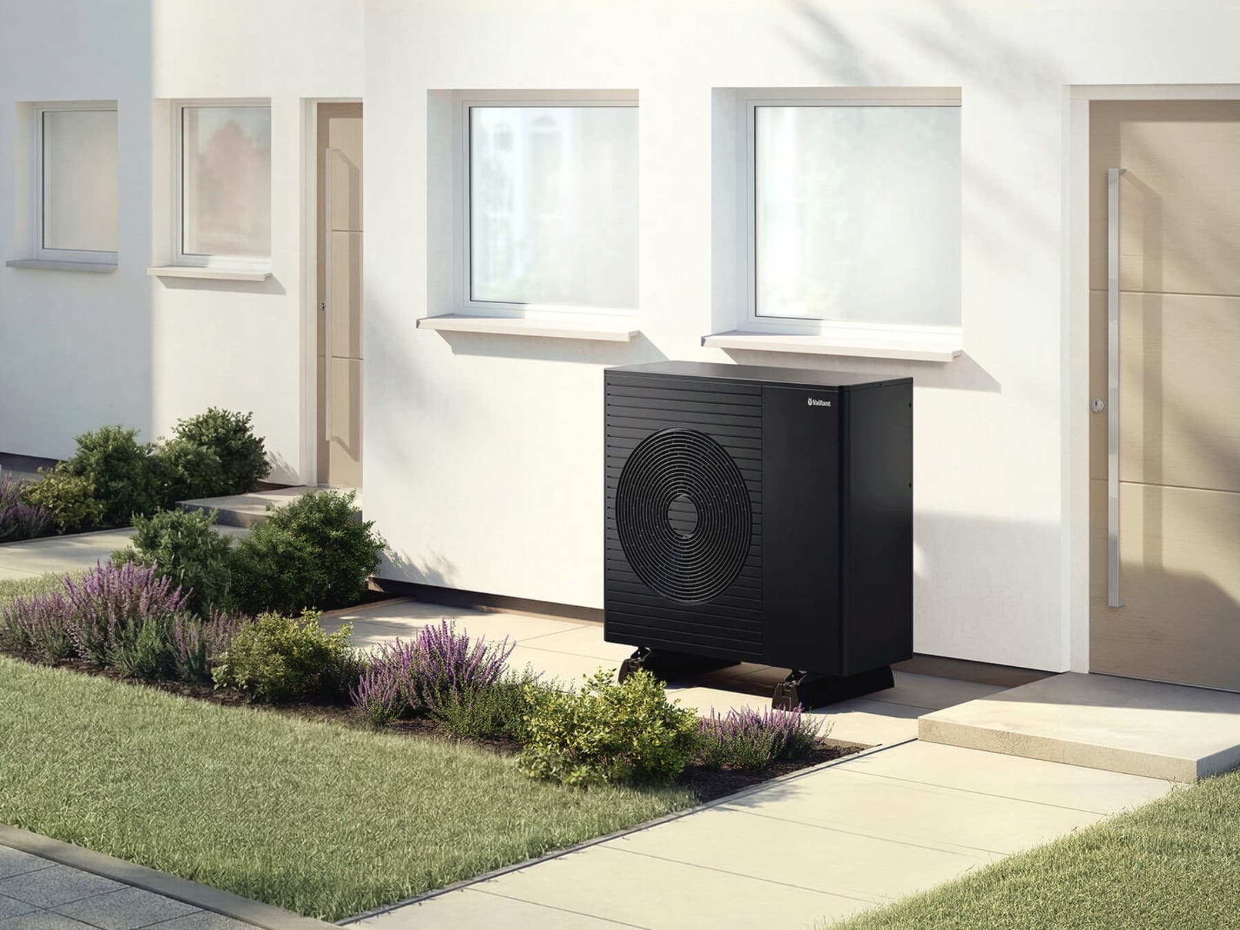 A building with many windows has many thermal bridges. An aroTHERM pro heat pump is located in front of the house