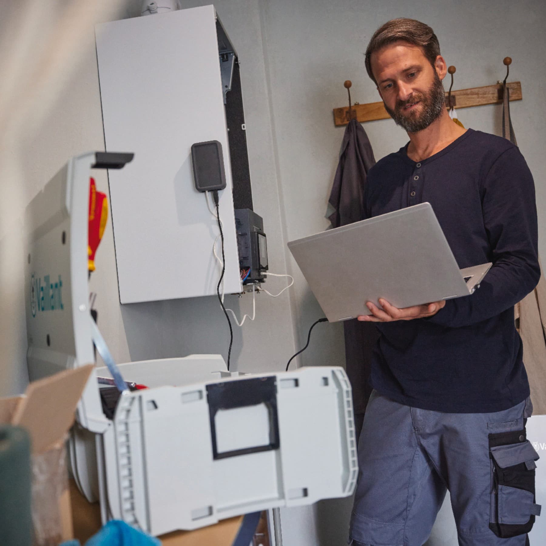A plumber performs boiler maintenance