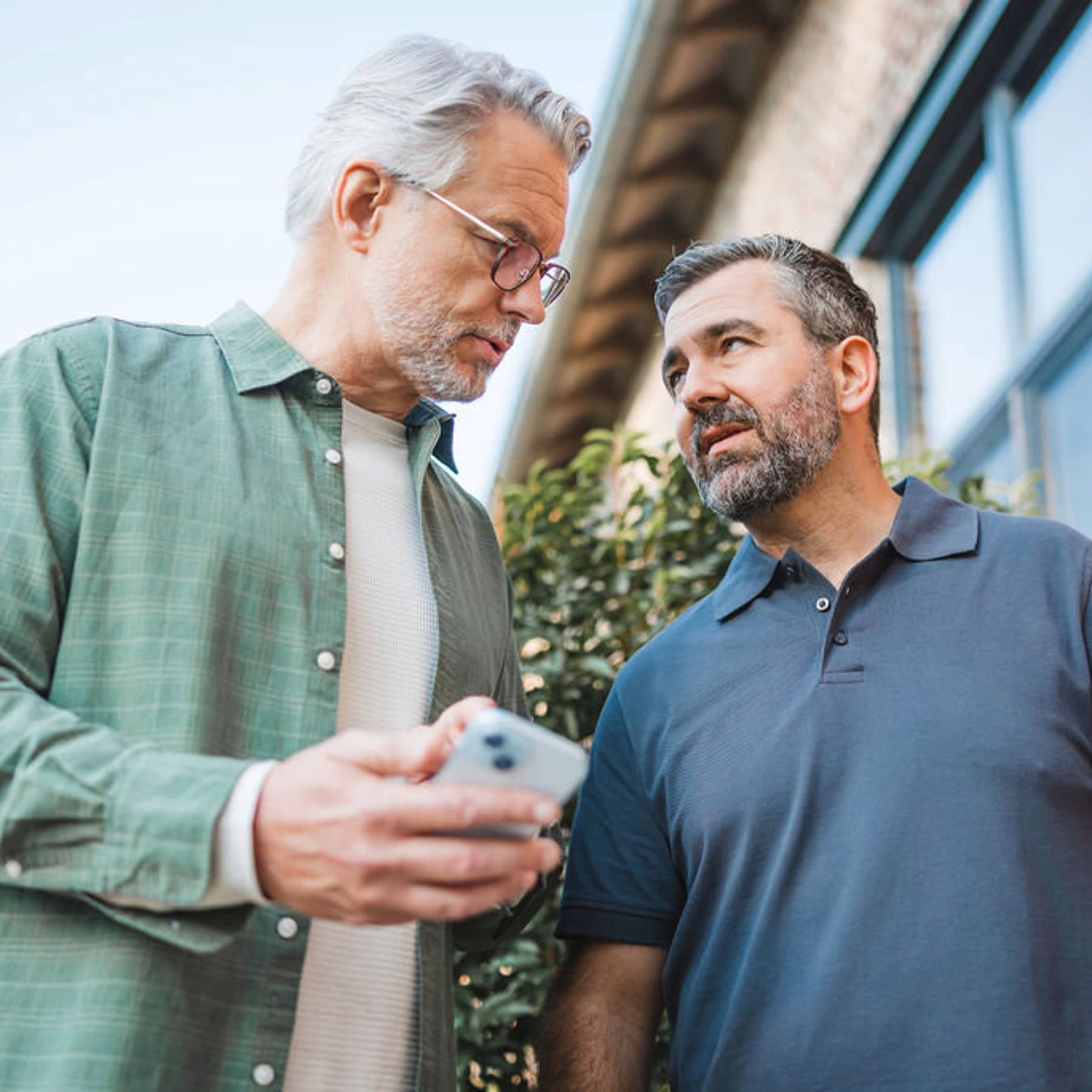 Installer and end user talking in front of heat pump