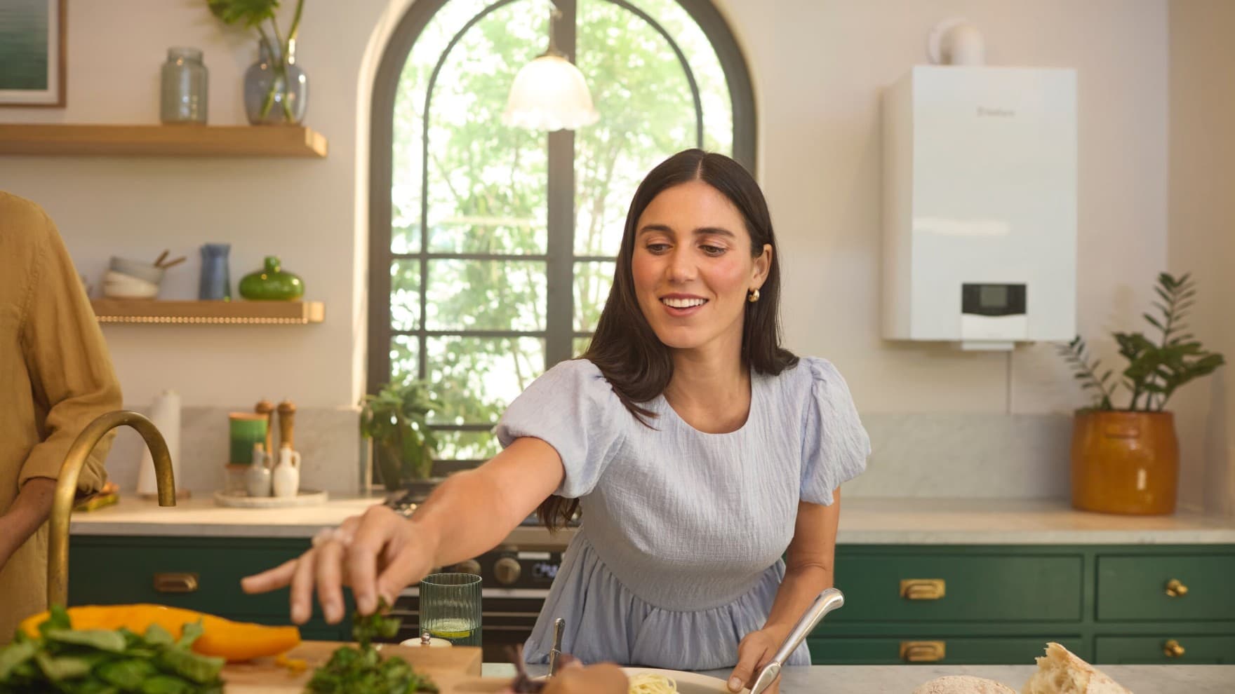 Woman in a kitchen in front of a boiler