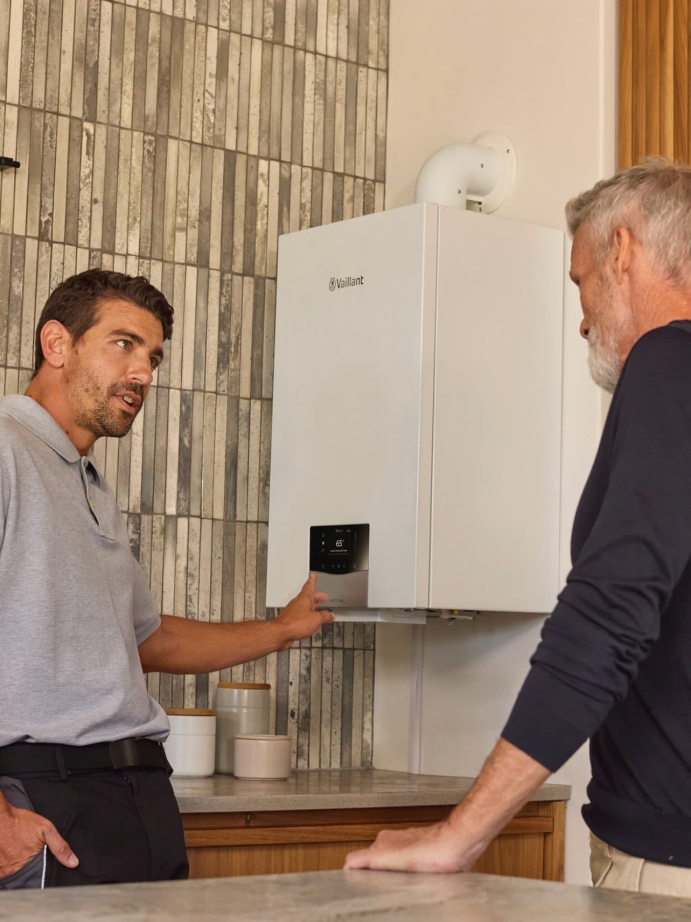 An installer explaining a boiler to a customer