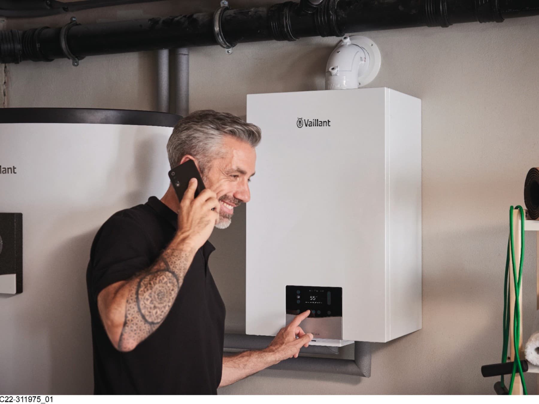 Vaillant installer working at boiler for maintenance.